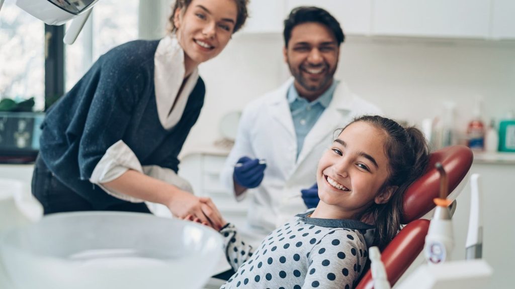 Dentist welcoming a young patient