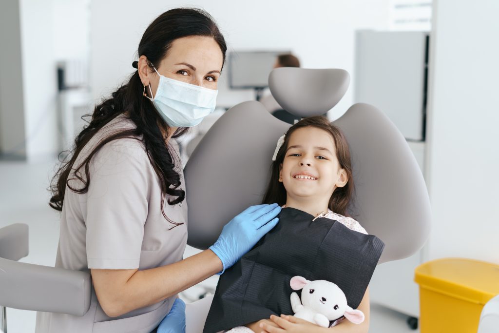 Young girl smiling at the dentist